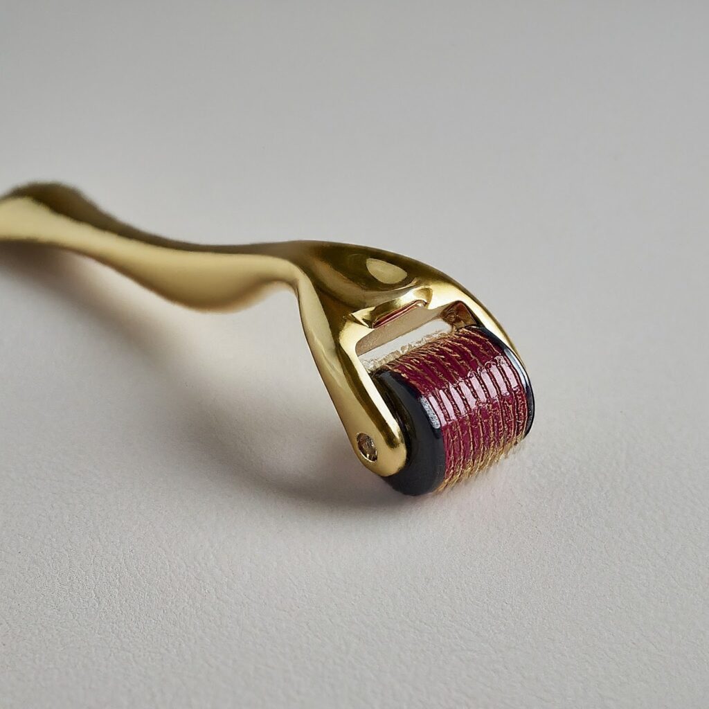 Close-up of a derma roller with fine needles, used for skincare treatments and microneedling to improve skin texture.