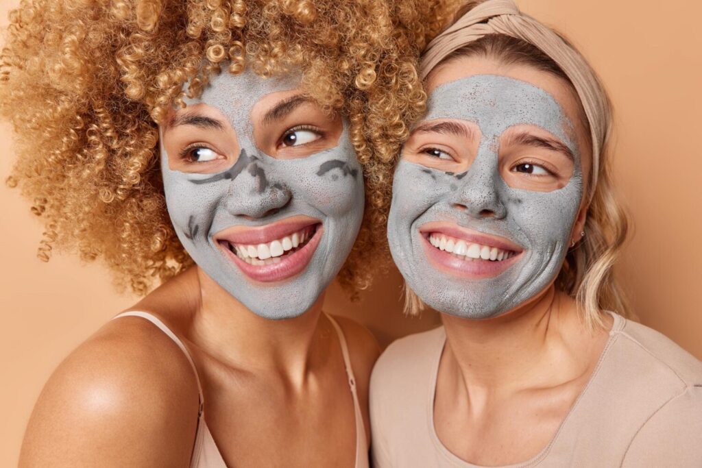 Smiley girls with skincare mask on their face