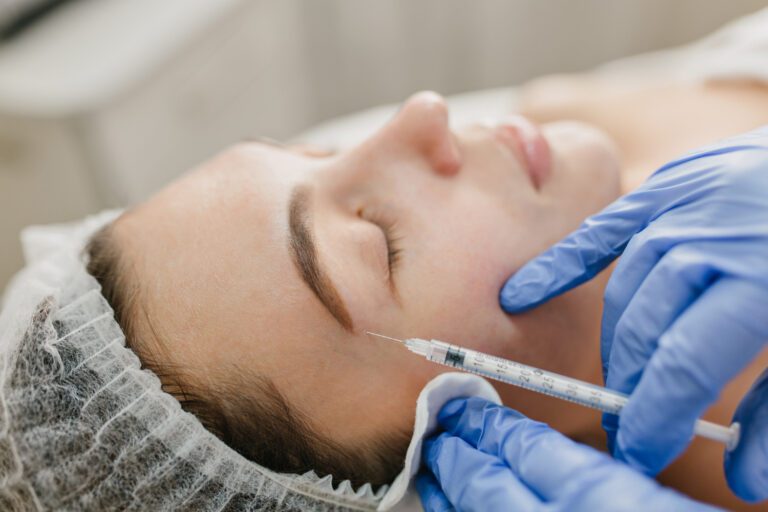 Close-up of a woman's face receiving a skin whitening injection treatment for brighter and even skin tone.