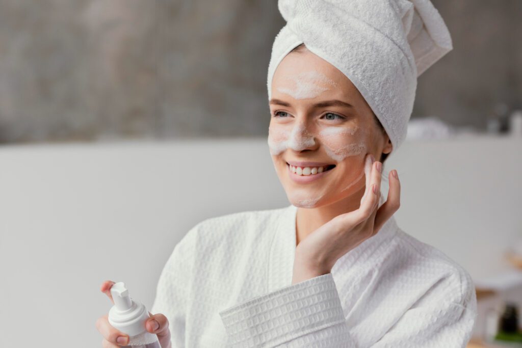 A girl performing a face clean up by cleansing her skin with a gentle facial cleanser.