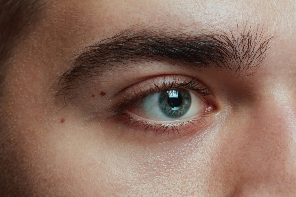 Close-up portrait of young man with visible open pores, highlighting skin texture for open pores treatment concerns.