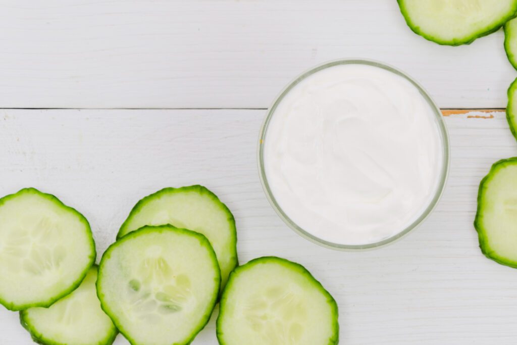 Cucumber slices with raw milk, a natural remedy for removing tan from the face and soothing skin.