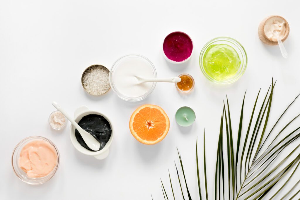 Flat lay of natural products like honey, turmeric,lemon, homemade scrubs and aloe vera, commonly used in home remedies for tan skin care and skin brightening.