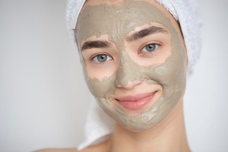 Portrait of a beautiful woman with a Multani Mitti mask on her face, showcasing the benefits of Multani Mitti uses for face care.