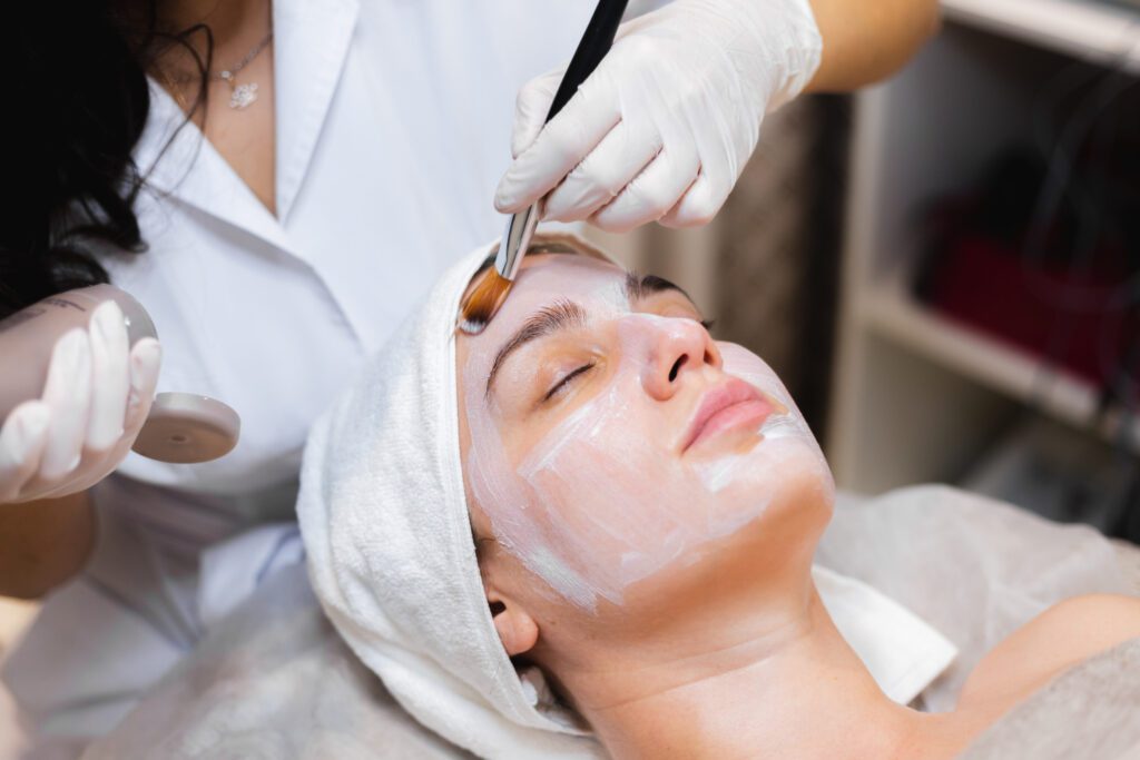 Dermatologist performing skin polishing treatment on a young girl for smoother, glowing skin.